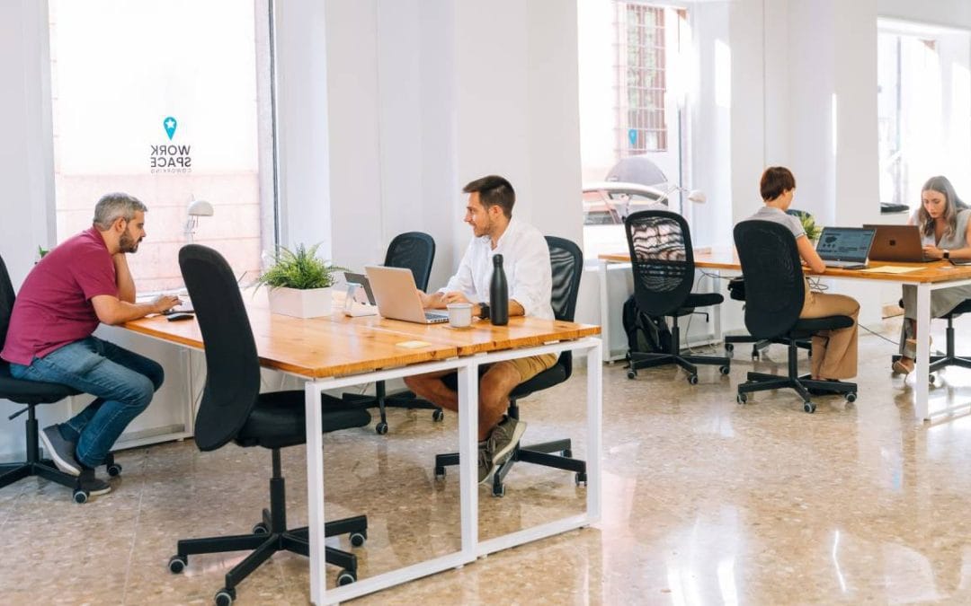Profesionales trabajando con portátiles en un coworking de Almería durante una jornada de prueba flexible.