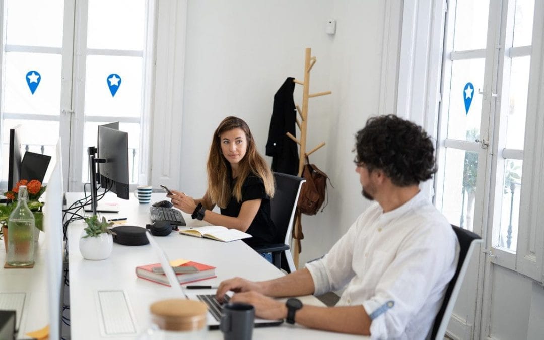 Dos profesionales trabajando en un espacio de coworking con puestos compartidos en Almería.