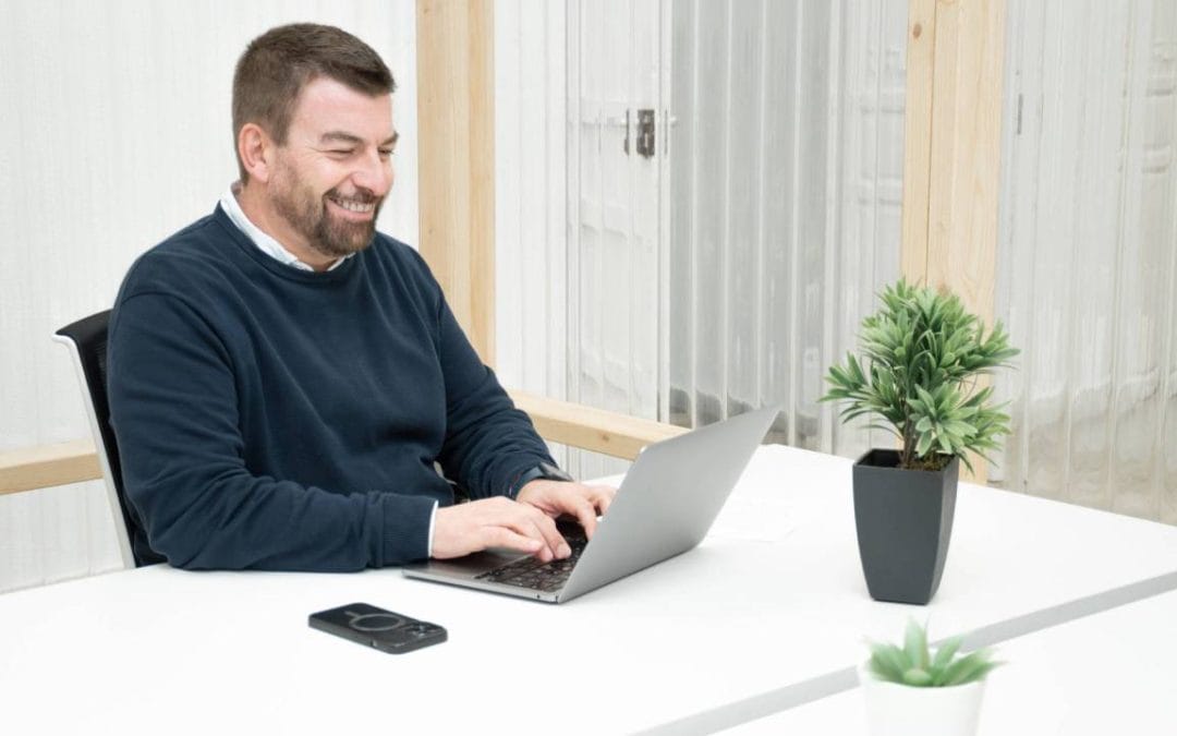 Profesional trabajando con portátil en un coworking de Almería en un ambiente cómodo y luminoso.